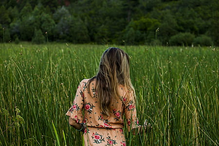 Photo of Woman Standing in Grass Field thumbnail