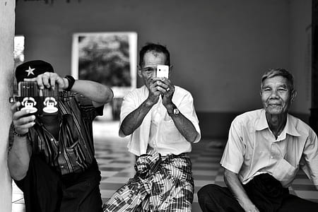 grayscale photo of three men sitting thumbnail