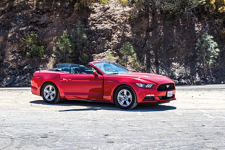 red Ford Mustang parked near mountain thumbnail