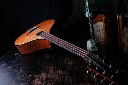 brown 8-string musical instrument on black wooden surface thumbnail