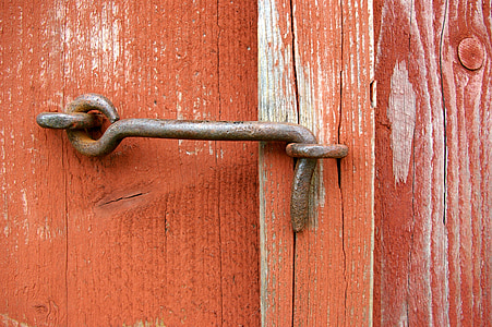 brown metal door latch locked on orange wooden surface thumbnail