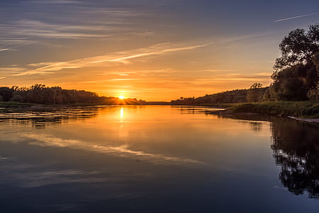 calm body of water under clear blue sky thumbnail