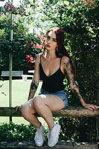 woman sitting on brown bench at the garden thumbnail