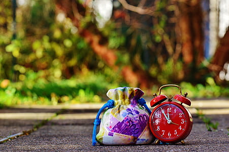 red alarm bell clock near drawstring pouch thumbnail