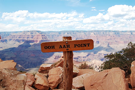 brown wooden ooh aah point post signage near rocks thumbnail