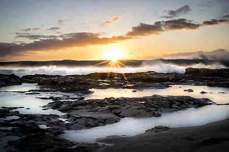 silhouette photo of rock formation during golden hour thumbnail