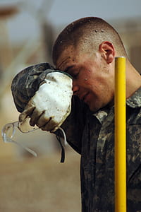 man holding eyeglasses wiping his face thumbnail