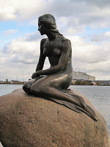 gray mermaid statue on brown stone thumbnail