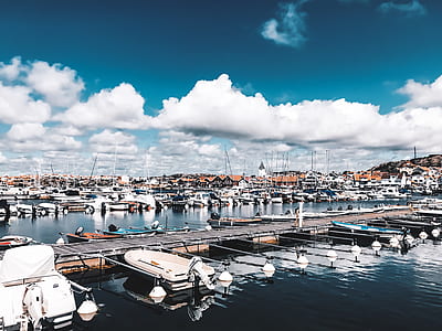 boats on body of water beside houses thumbnail