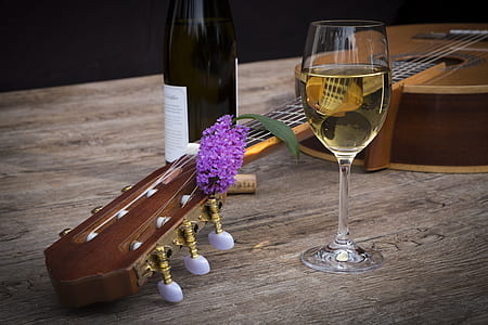 brown classic guitar between wine glass and bottle thumbnail
