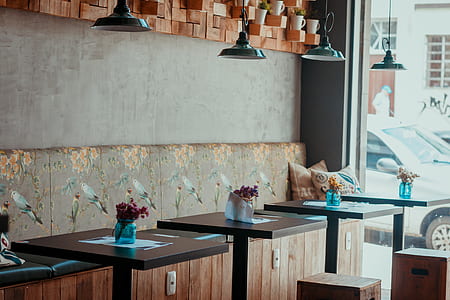 pile of brown wooden tables under black pendant lamp thumbnail