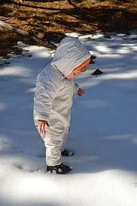 baby standing on snow during daytime thumbnail