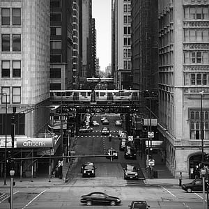 grayscale photography of street between big buildings thumbnail