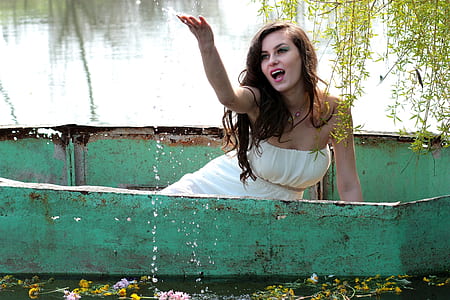 woman on boat raising her right hand thumbnail
