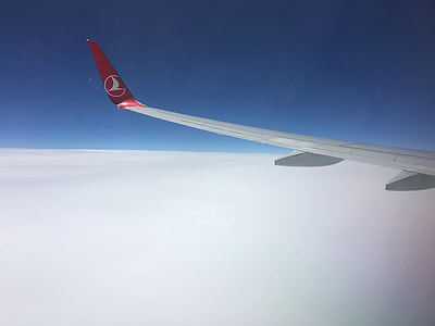 white and red airplane under blue sky at daytime thumbnail