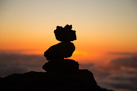 Silhouette of a pile of rocks at sunset thumbnail