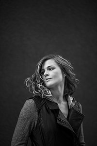 women's gray scale photo selective with black sleeveless coat and gray long sleeve hoodie shirt thumbnail