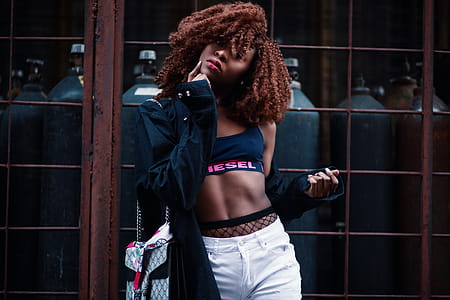 Woman Wearing Black and Pink Diesel Sports Bra With Black Jacket and White Bottoms Outfit thumbnail