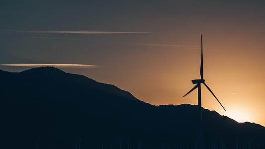 silhouette of windmill at golden hour thumbnail