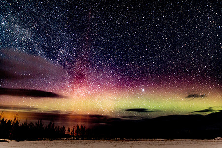 time lapse photography and landscape photography of sand dunes and stars during nighttime thumbnail