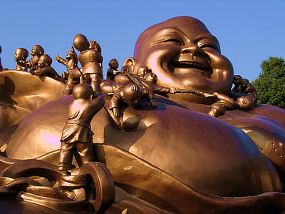laughing Buddha statue during daytime thumbnail
