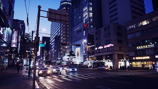 low-light photo of cars near buildings thumbnail