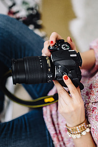 Woman in pink with her camera thumbnail