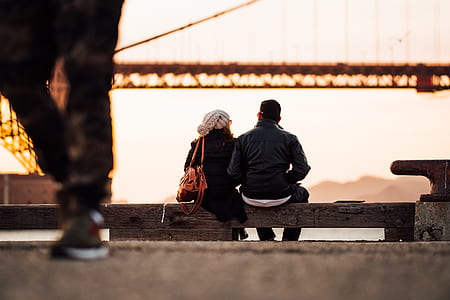 man and woman sitting on bench thumbnail