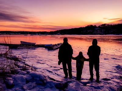 silhouette of person standing in front of body of water thumbnail