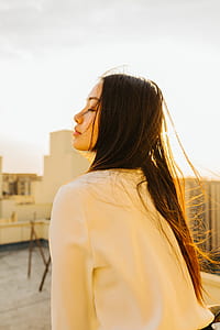 woman wearing white long-sleeved shirt during daytime thumbnail
