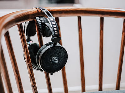 black wireless headphones hanged brown chair thumbnail