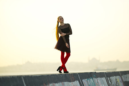 Fashion model with long hair wearing socks on coast thumbnail