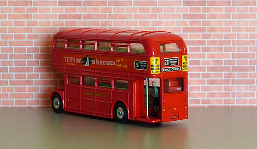 red 2-storey bus toy near wall thumbnail