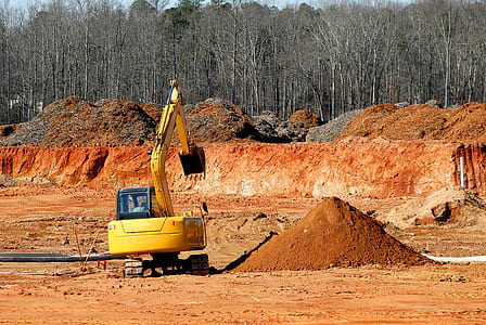 yellow excavator digging on brown land thumbnail