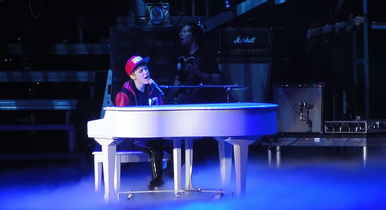 Justin Bieber playing piano while singing thumbnail