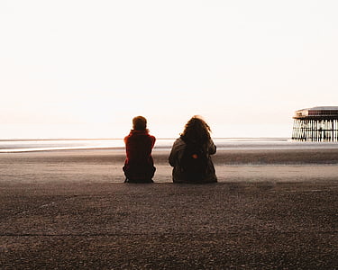 two person sitting on gray surface thumbnail