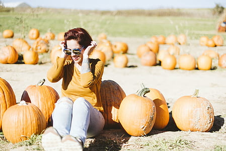 woman surrounded by pumpkins thumbnail