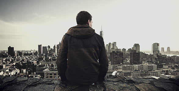 person sitting at the edge overlooking the city thumbnail