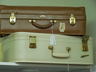 two white and brown leather luggage on white shelf thumbnail