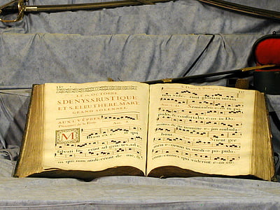 music book on gray textile thumbnail