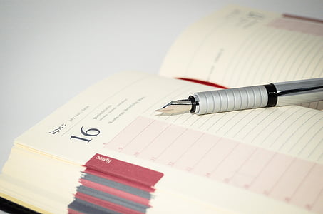 fountain pen on beige ruled notebook thumbnail