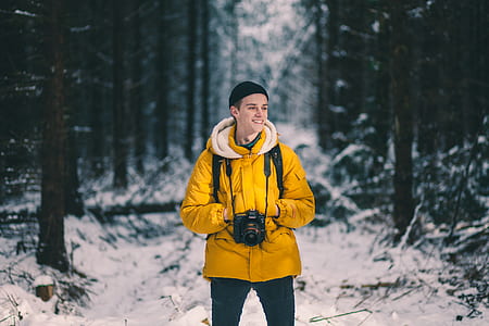 man holding black DSLR camera thumbnail