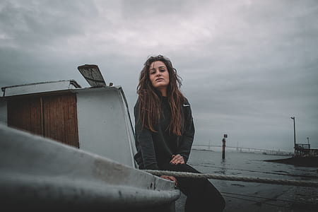 woman sitting on gray concrete railings thumbnail
