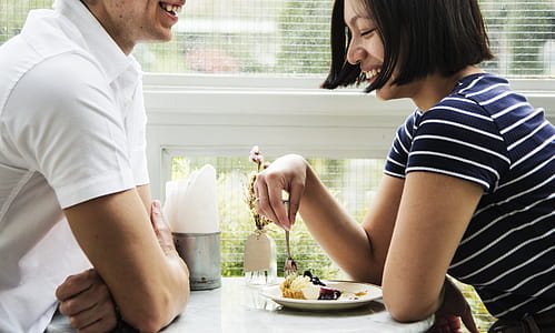 Man and Woman Sitting While Facing Each Other thumbnail