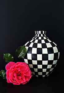 red rose near white and black checked ceramic vase thumbnail