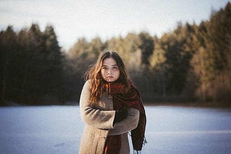 woman standing surrounded by trees during daytime thumbnail