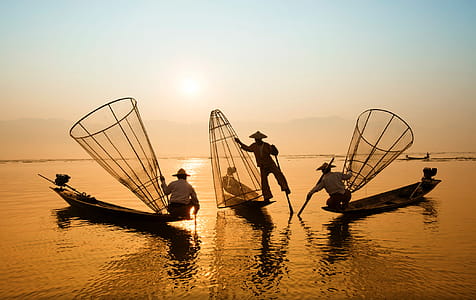 Three Men Riding Boats on Body of Water thumbnail
