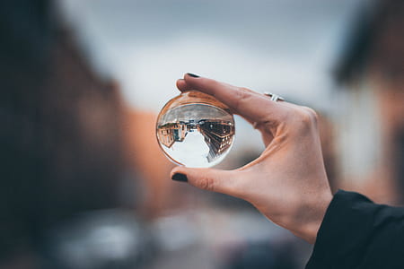 person holding glass ball thumbnail