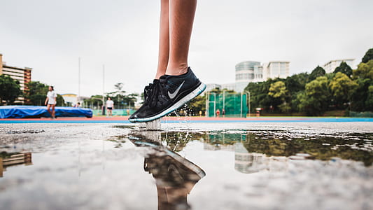 person jumping over water during daytime thumbnail