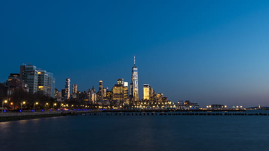 photography of cityscape of buildings beside body of water thumbnail